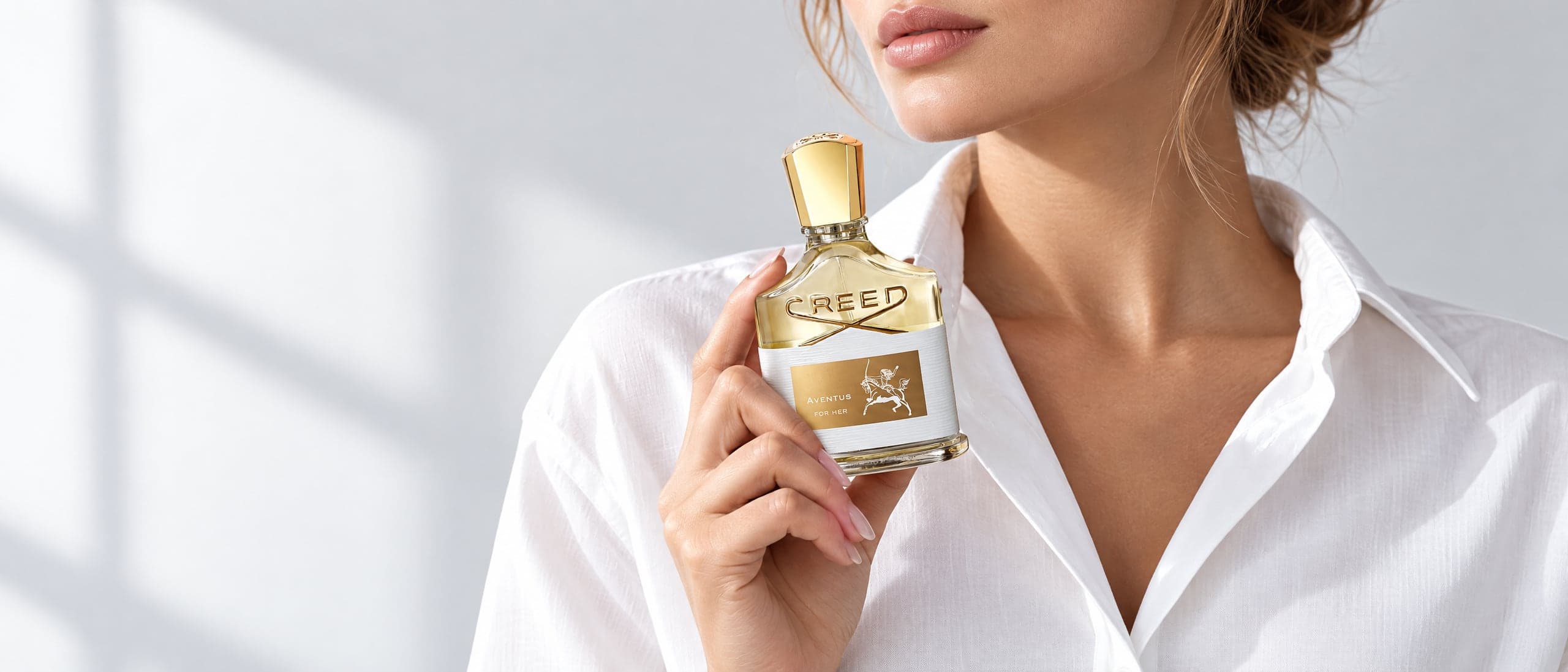 Creed Aventus For Her in a bright studio